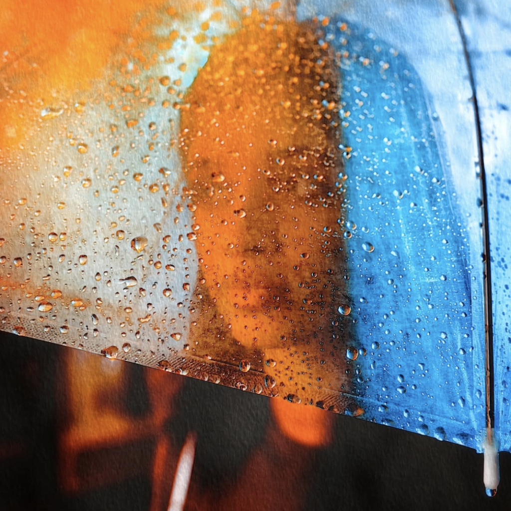 black woman portrait behind glass with blue hair