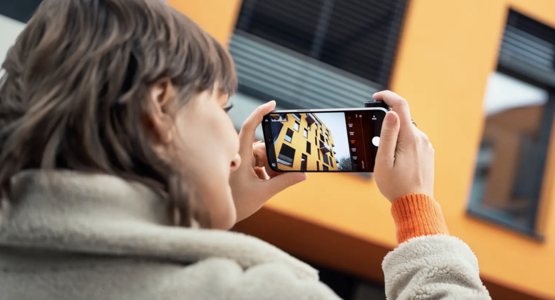 photograph a woman taking a photo with the Leica Pro app