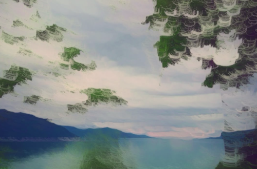 Abstract landscape photograph of a tranquil lake framed by trees, with impressionistic camera movement creating layered green foliage, soft pastel skies and shimmering reflections across the water.