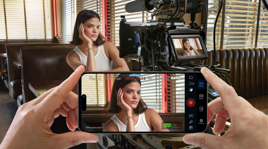 Blackmagic Camera app on iPhone used alongside a professional cinema camera for high-quality mobile filmmaking.
