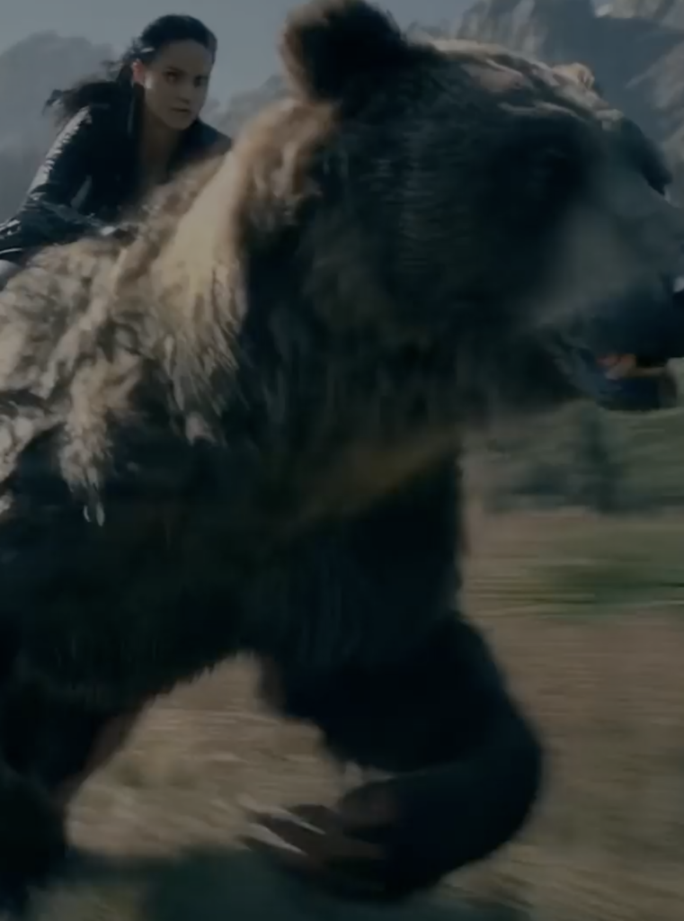 Luma Dream Machine AI video generation example showing a woman racing alongside a charging bear across a dramatic mountain landscape, demonstrating the platform's ability to create dynamic cinematic action with realistic movement and detailed environments.