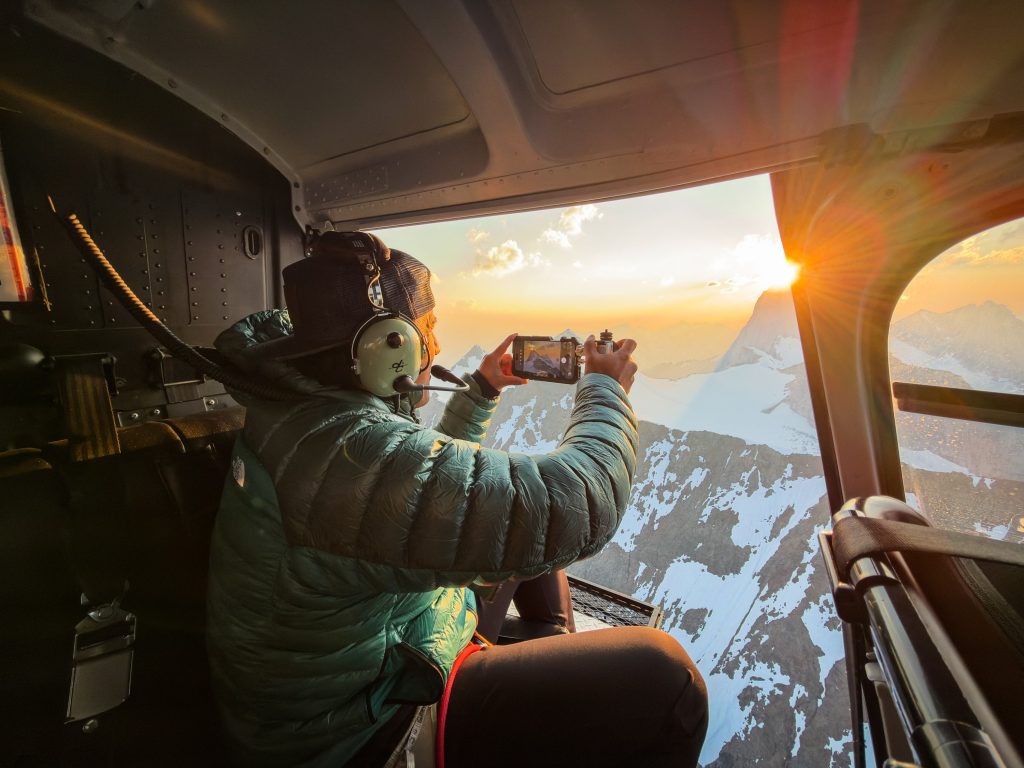Jimmy Chin photographing from a helicopter with iPhone 18 Pro