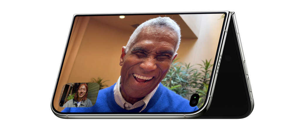 Apple iPhone Duo partially folded and standing unsupported during a FaceTime video call.